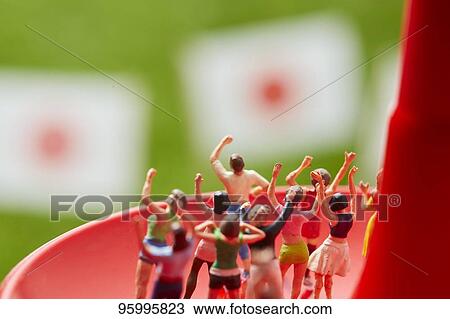 Miniature figures cheering View Large Photo Image Stock Image - Miniature figures cheering. Fotosearch