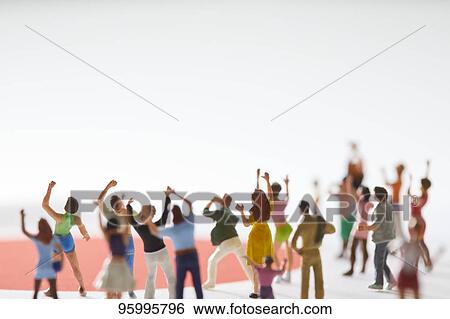 Miniature figures cheering View Large Photo Image Stock Photograph - Miniature figures cheering. Fotosearch