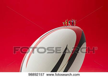 Stock Photo - Miniatures and rugby ball. Fotosearch