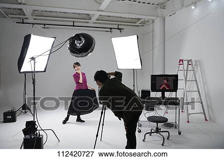 Stock Photo - Model photo shoot in a studio. Fotosearch
