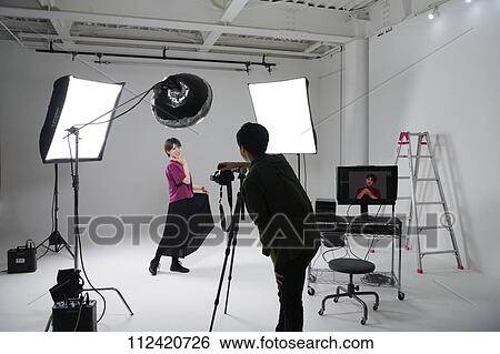 Model photo shoot in a studio View Large Photo Image Stock Photograph - Model photo shoot in a studio. Fotosearch