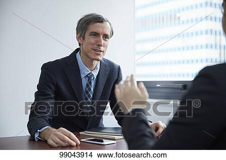 Picture - Multi-ethnic business people having meeting. Fotosearch
