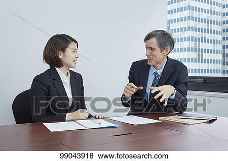 Multi-ethnic business people having meeting View Large Photo Image Stock Photo - Multi-ethnic business people having meeting. Fotosearch