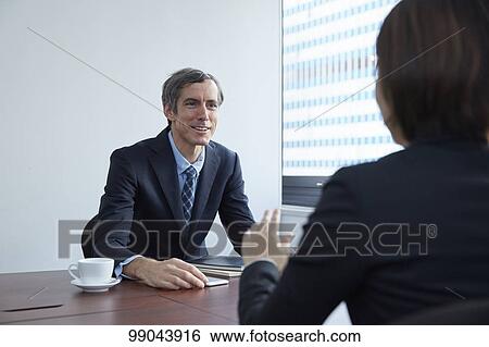 Multi-ethnic business people having meeting View Large Photo Image Stock Photograph - Multi-ethnic business people having meeting. Fotosearch