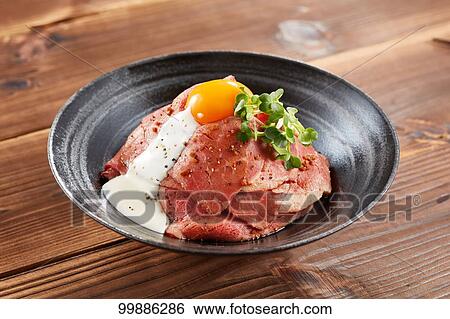 Stock Photograph - Roast beef rice bowl. Fotosearch