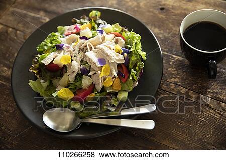 Stock Photo - Salad and coffee on wooden table. Fotosearch