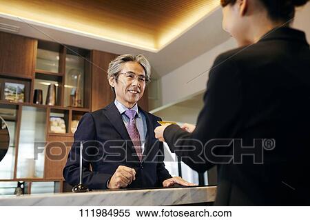 Senior businessman checking in at hotel View Large Photo Image Stock Photography - Senior businessman checking in at hotel. Fotosearch