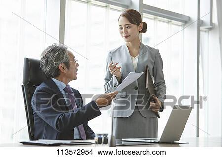 Picture - Senior Japanese businessman with his assistant. Fotosearch