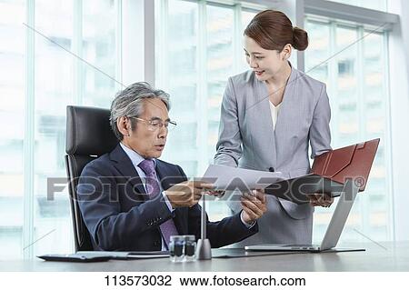 Stock Image - Senior Japanese businessman with his assistant. Fotosearch