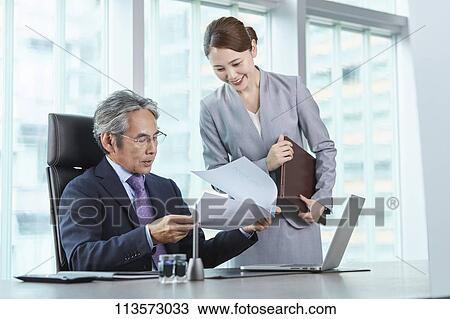 Stock Image - Senior Japanese businessman with his assistant. Fotosearch