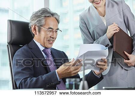 Senior Japanese businessman with his assistant View Large Photo Image Stock Photo - Senior Japanese businessman with his assistant. Fotosearch