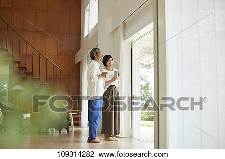 Stock Image - Senior Japanese couple at home. Fotosearch
