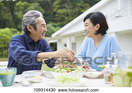 Stock Image - Senior Japanese couple at home. Fotosearch