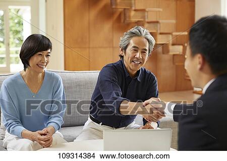 Senior Japanese couple at home with salesman View Large Photo Image Picture - Senior Japanese couple at home with salesman. Fotosearch