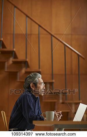 Stock Photo - Senior Japanese man at home. Fotosearch