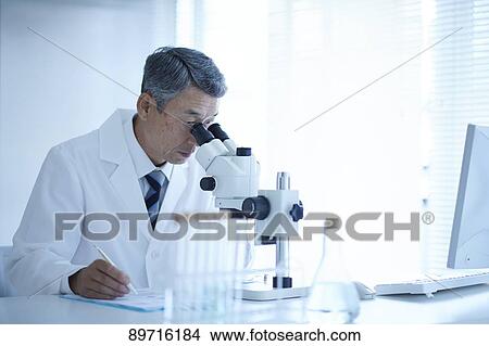 Picture - Senior Japanese researcher in the lab. Fotosearch