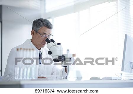 Picture - Senior Japanese researcher in the lab. Fotosearch
