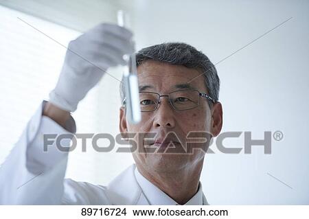 Picture - Senior Japanese researcher in the lab. Fotosearch