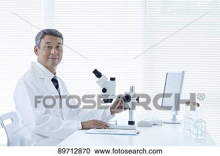 Stock Image - Senior Japanese researcher in the lab. Fotosearch