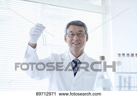 Stock Image - Senior Japanese researcher in the lab. Fotosearch
