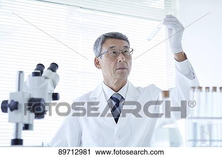 Stock Image - Senior Japanese researcher in the lab. Fotosearch