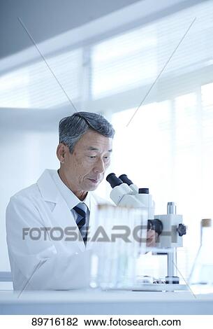 Stock Image - Senior Japanese researcher in the lab. Fotosearch
