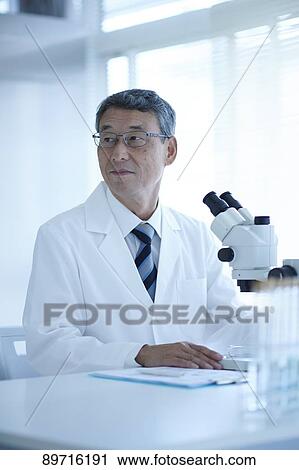 Stock Image - Senior Japanese researcher in the lab. Fotosearch
