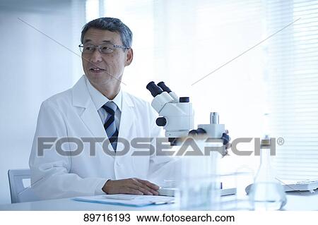 Stock Image - Senior Japanese researcher in the lab. Fotosearch