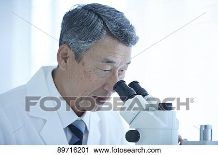 Stock Image - Senior Japanese researcher in the lab. Fotosearch