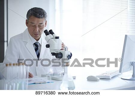 Stock Image - Senior Japanese researcher in the lab. Fotosearch