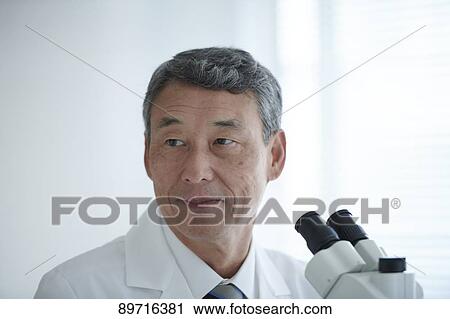 Stock Image - Senior Japanese researcher in the lab. Fotosearch