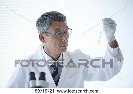 Stock Image - Senior Japanese researcher in the lab. Fotosearch