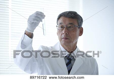Stock Image - Senior Japanese researcher in the lab. Fotosearch