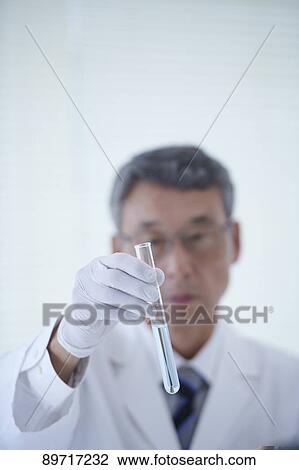 Stock Image - Senior Japanese researcher in the lab. Fotosearch