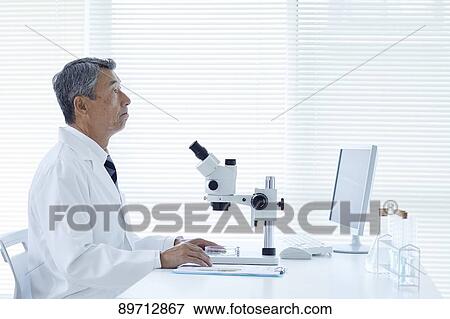 Stock Photo - Senior Japanese researcher in the lab. Fotosearch