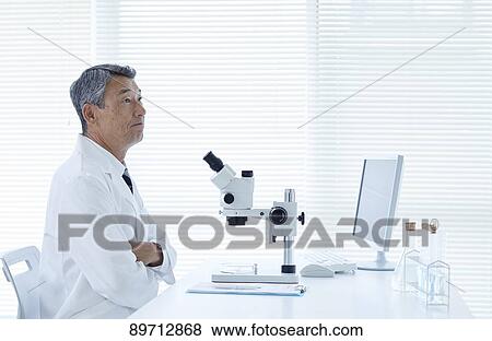 Stock Photo - Senior Japanese researcher in the lab. Fotosearch