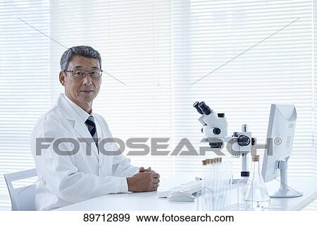 Stock Photo - Senior Japanese researcher in the lab. Fotosearch