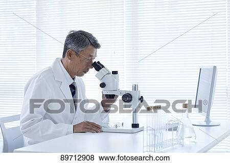 Stock Photo - Senior Japanese researcher in the lab. Fotosearch