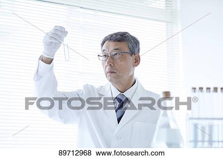 Stock Photo - Senior Japanese researcher in the lab. Fotosearch