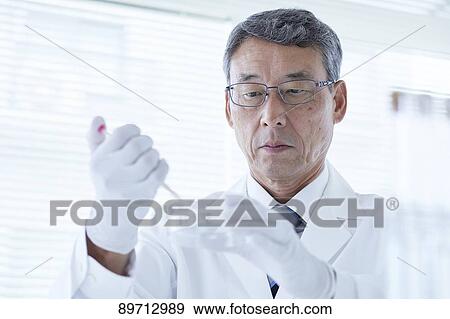 Stock Photo - Senior Japanese researcher in the lab. Fotosearch