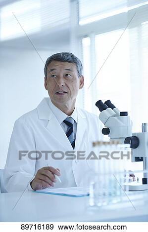 Stock Photo - Senior Japanese researcher in the lab. Fotosearch