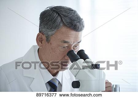 Stock Photo - Senior Japanese researcher in the lab. Fotosearch