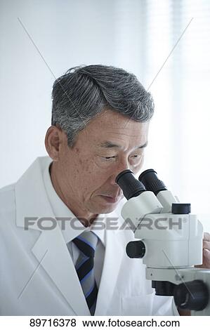 Stock Photo - Senior Japanese researcher in the lab. Fotosearch