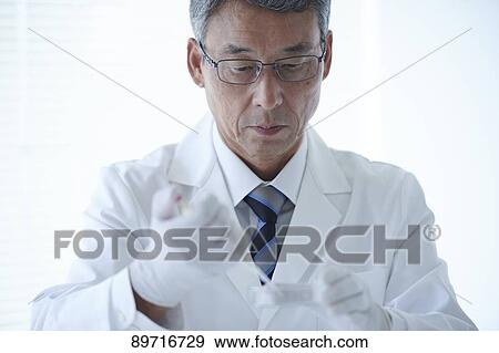 Stock Photo - Senior Japanese researcher in the lab. Fotosearch