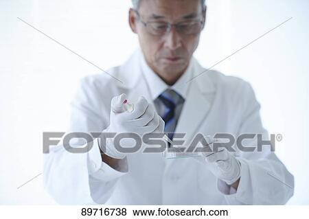 Stock Photo - Senior Japanese researcher in the lab. Fotosearch