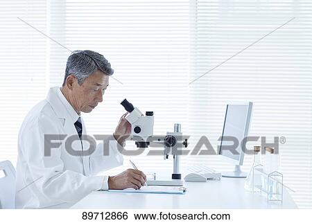 Stock Photograph - Senior Japanese researcher in the lab. Fotosearch