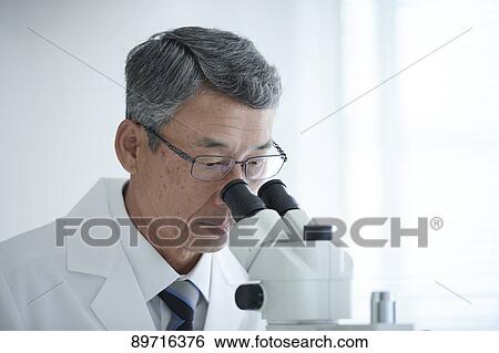 Stock Photograph - Senior Japanese researcher in the lab. Fotosearch