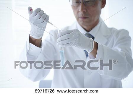 Stock Photograph - Senior Japanese researcher in the lab. Fotosearch