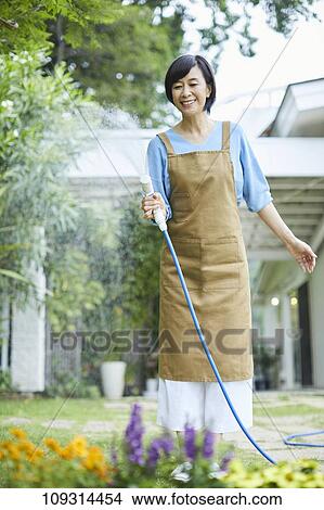 Senior Japanese woman gardening View Large Photo Image Picture - Senior Japanese woman gardening. Fotosearch