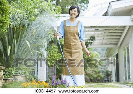Senior Japanese woman gardening View Large Photo Image Stock Photo - Senior Japanese woman gardening. Fotosearch